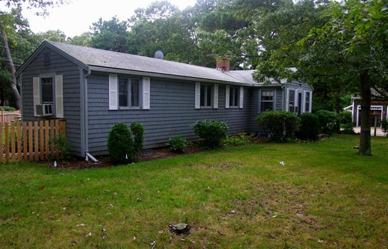 169 Foster Road Brewster, MA 02631 - Photo 2 of 14 a front view of a house with garden