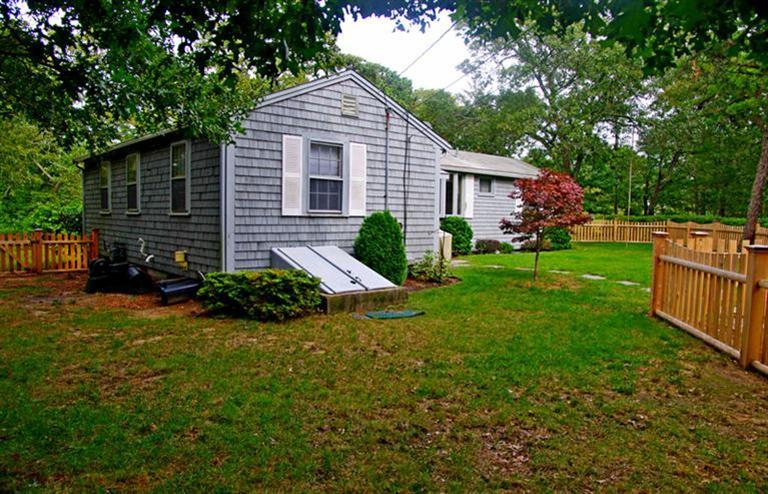 169 Foster Road Brewster, MA 02631 - Photo 4 of 14 a front view of house with yard and green space