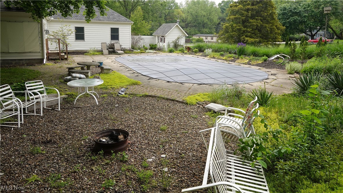 4088 Manchester Road Akron, OH 44319 - Photo 42 of 50 View of yard featuring a patio, a covered pool, and an outbuilding