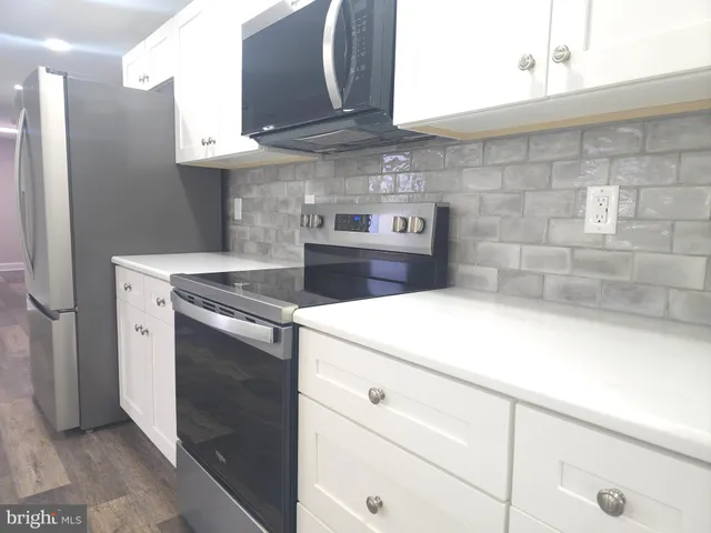 a kitchen with a stove and cabinets