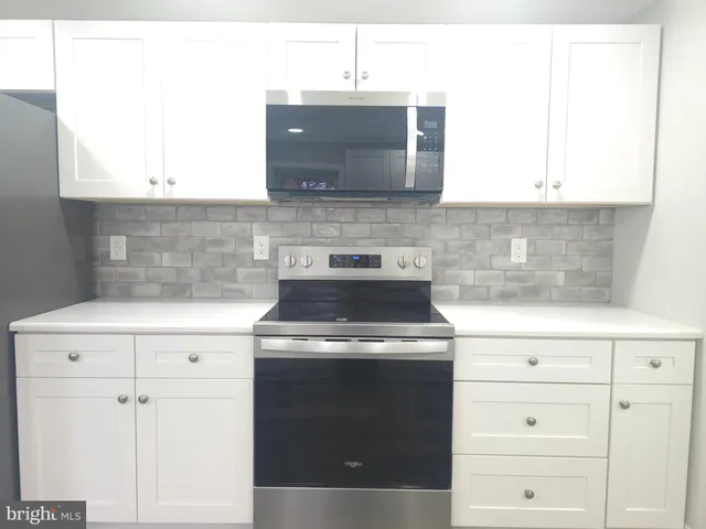 a stove top oven sitting inside of a kitchen