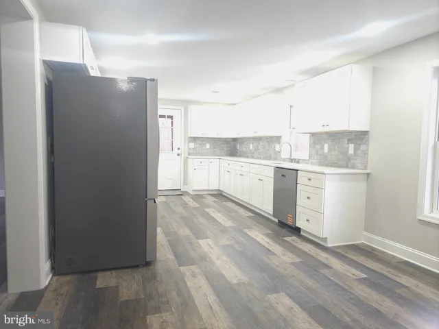 a kitchen with stainless steel appliances a refrigerator sink and cabinets