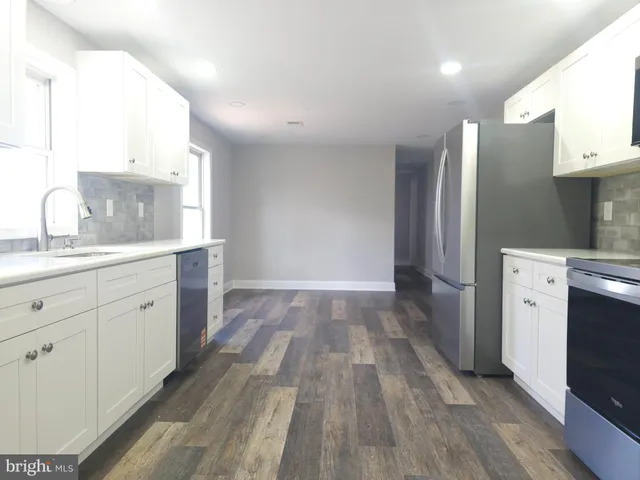 a kitchen with stainless steel appliances a refrigerator sink and cabinets