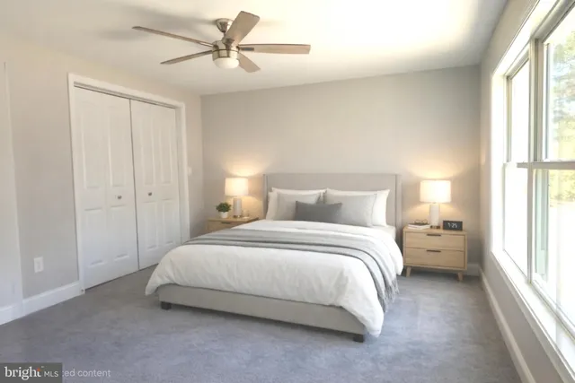 a spacious bedroom with a bed and a chandelier