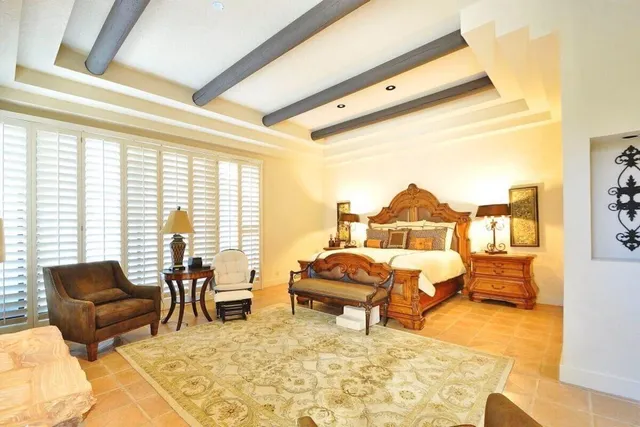 a bedroom with a bed a couch and dresser