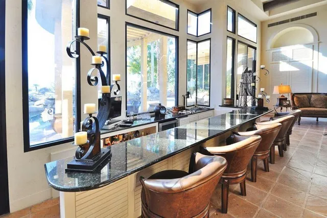 a kitchen with a large window and furniture