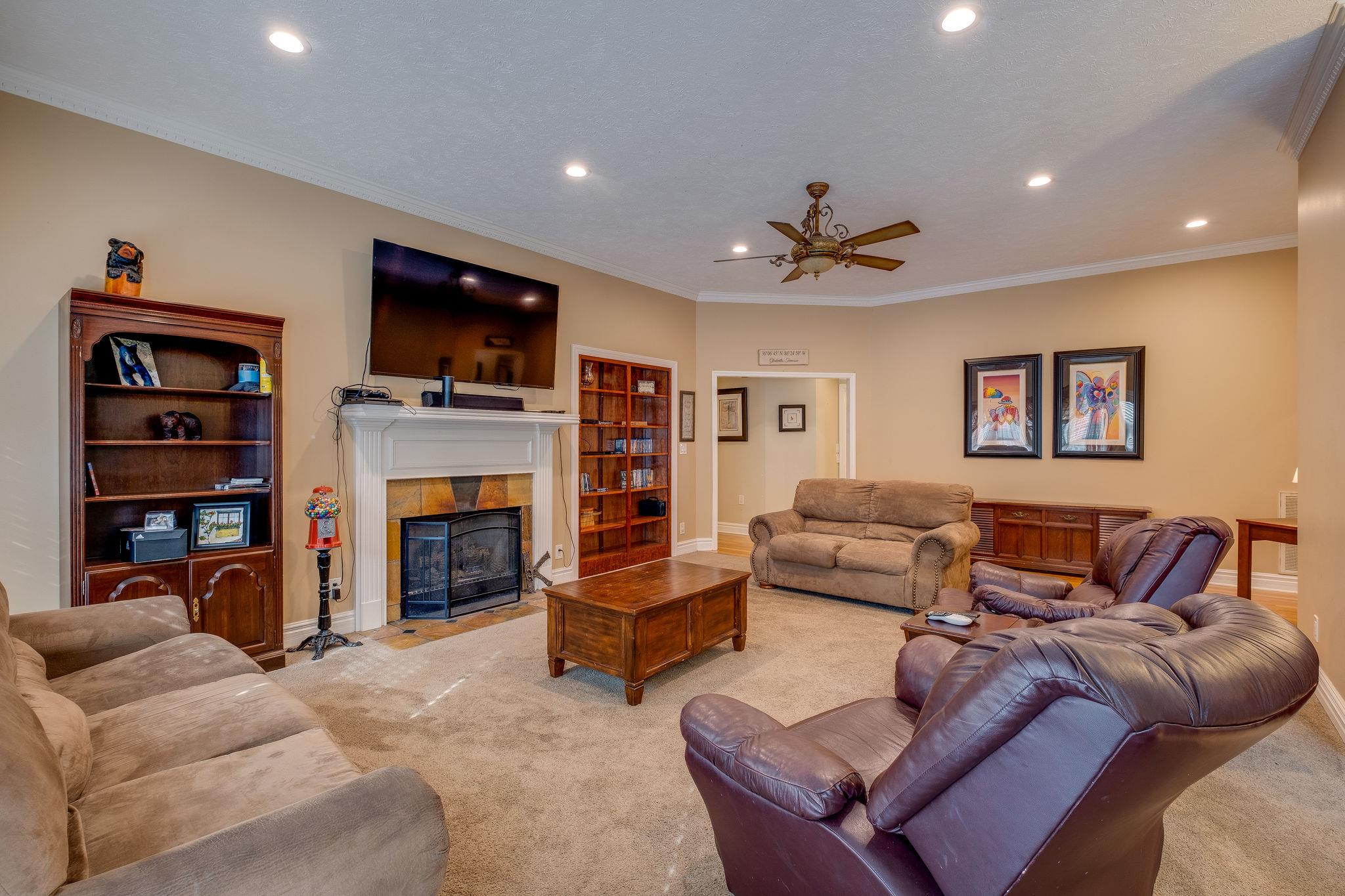 2700 Lone Oak Road Mount Juliet, TN 37122 - Photo 11 of 30 a living room with furniture a flat screen tv and a fireplace