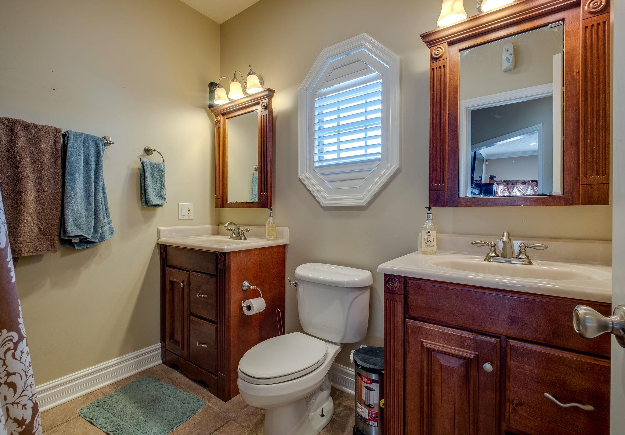 2700 Lone Oak Road Mount Juliet, TN 37122 - Photo 16 of 30 a bathroom with a toilet sink vanity granite and mirror