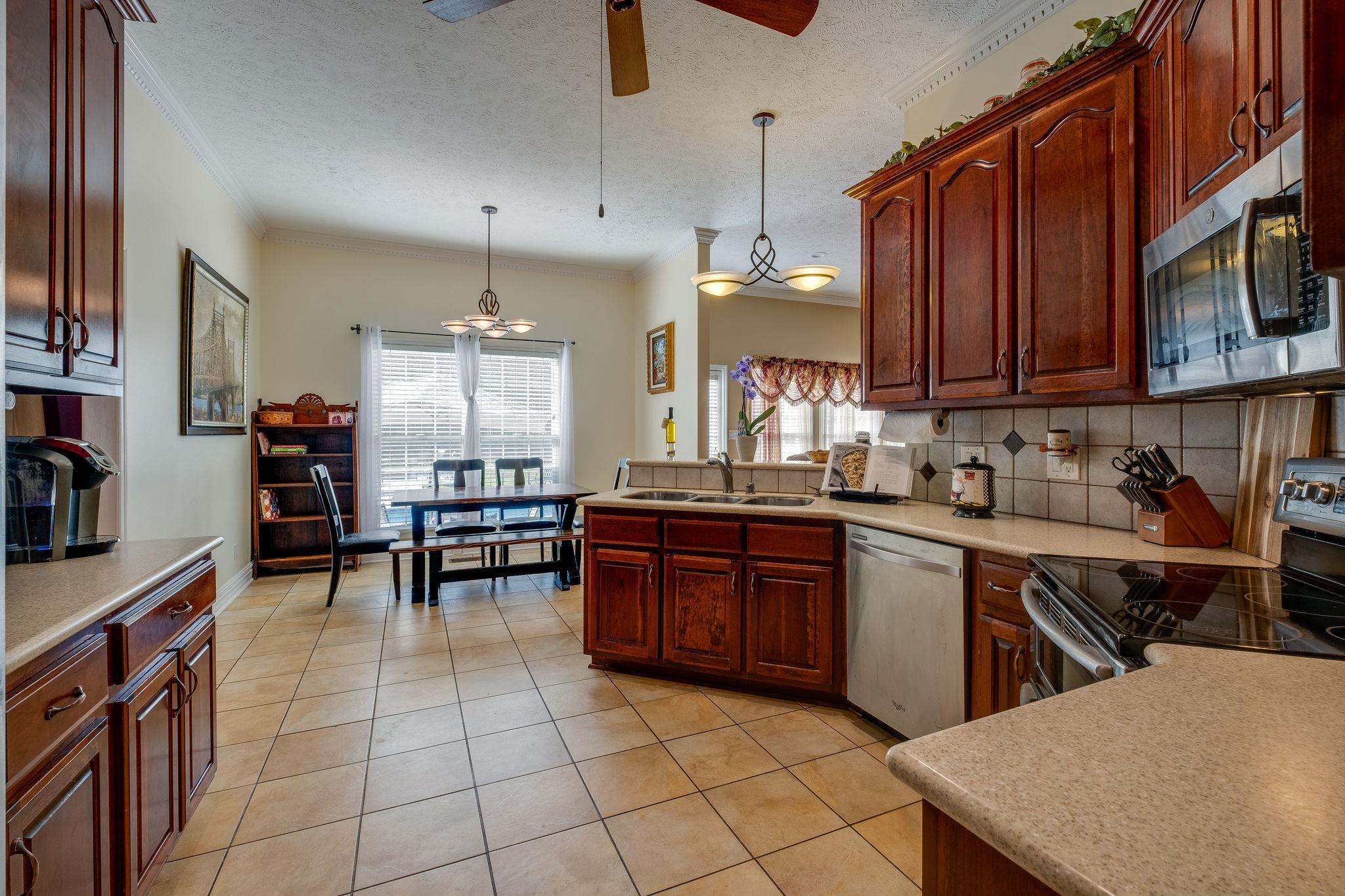 2700 Lone Oak Road Mount Juliet, TN 37122 - Photo 7 of 30 a kitchen with stainless steel appliances granite countertop a table chairs sink and cabinets