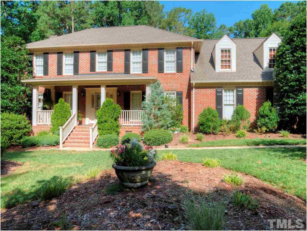 4709 Fallswood Place Raleigh, NC 27613 - Photo 1 of 25 a front view of a house with a yard and potted plants