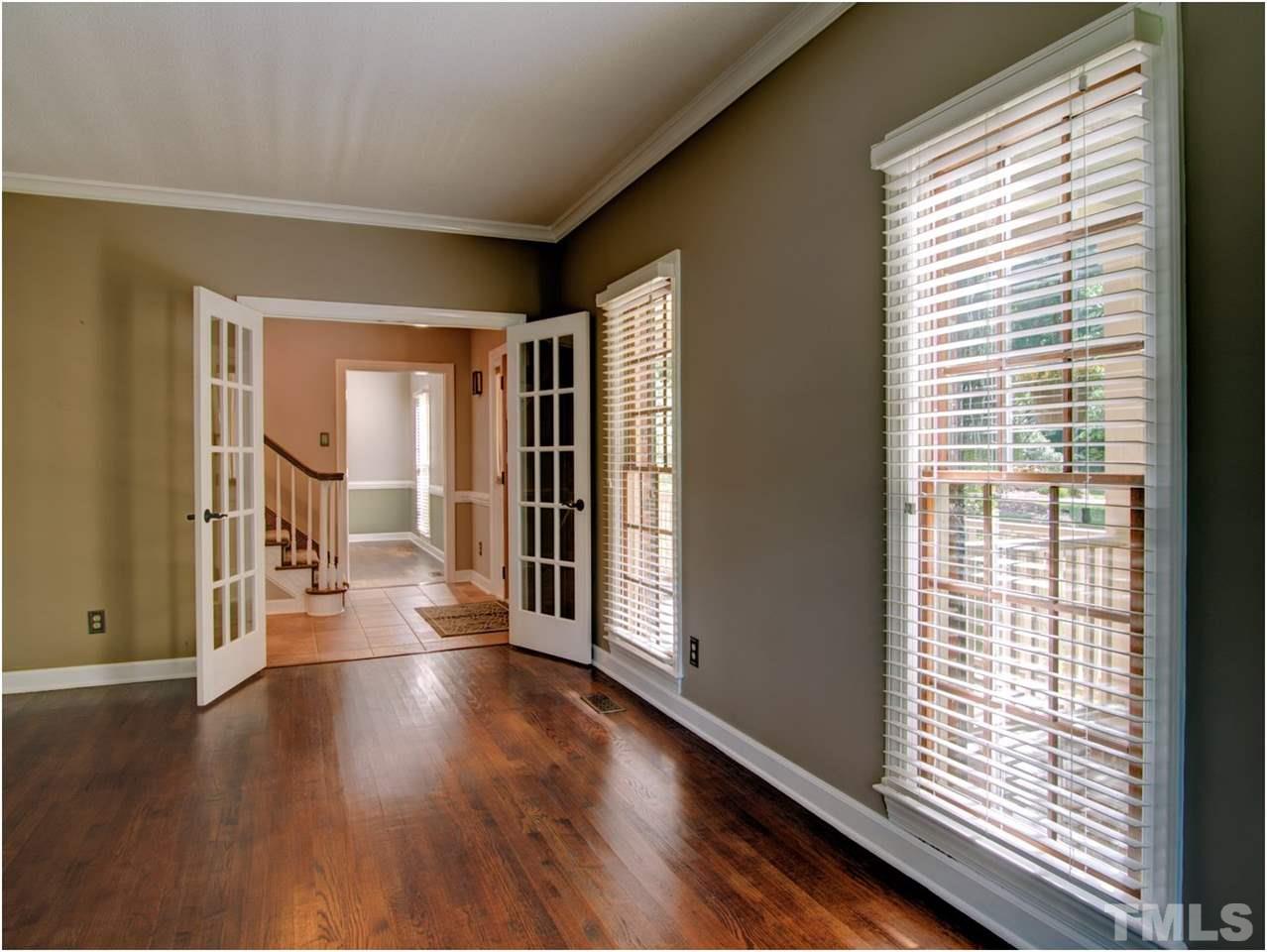 4709 Fallswood Place Raleigh, NC 27613 - Photo 12 of 25 a view of a big room with wooden floor and windows