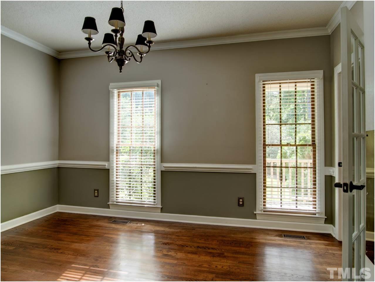 4709 Fallswood Place Raleigh, NC 27613 - Photo 13 of 25 a view of an empty room with wooden floor and a window