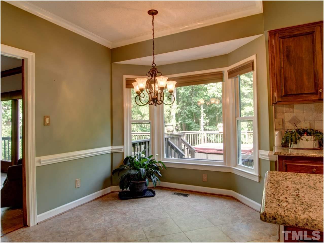 4709 Fallswood Place Raleigh, NC 27613 - Photo 17 of 25 a living room with furniture and a potted plant