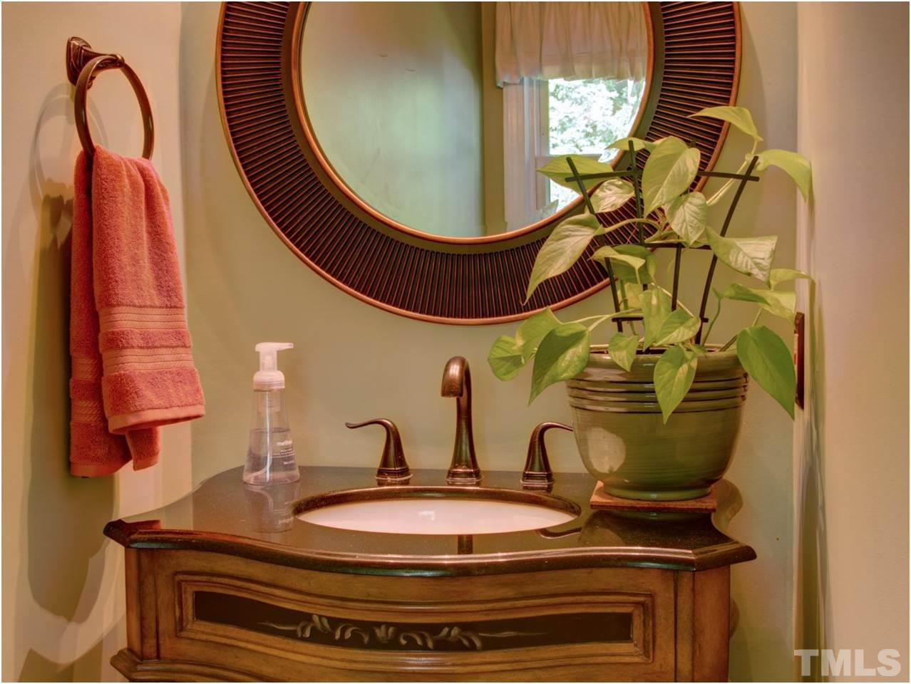 4709 Fallswood Place Raleigh, NC 27613 - Photo 18 of 25 a bathroom with a sink and mirror