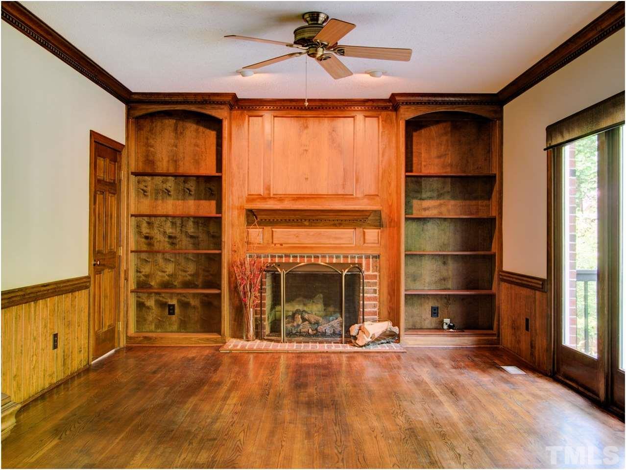 4709 Fallswood Place Raleigh, NC 27613 - Photo 19 of 25 an empty room with fireplace cabinet and window