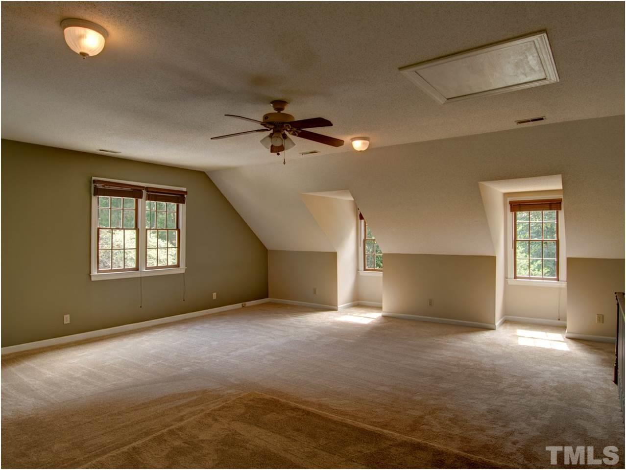 4709 Fallswood Place Raleigh, NC 27613 - Photo 22 of 25 a view of a livingroom with a ceiling fan and window