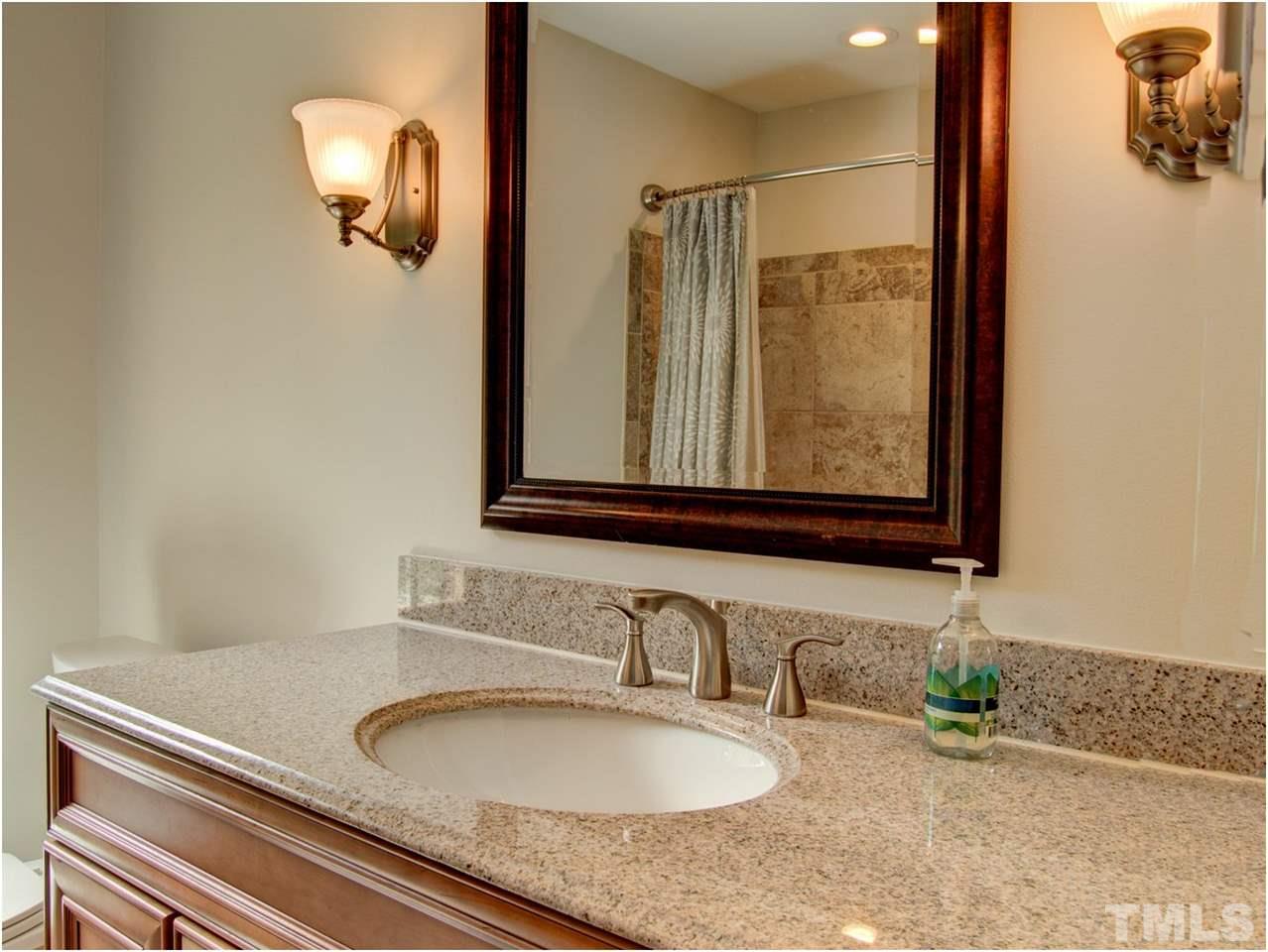 4709 Fallswood Place Raleigh, NC 27613 - Photo 25 of 25 a bathroom with a granite countertop sink and a mirror