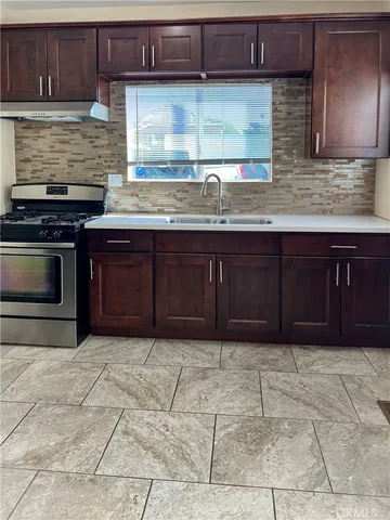 a view of kitchen and kitchen with granite countertop wooden floor