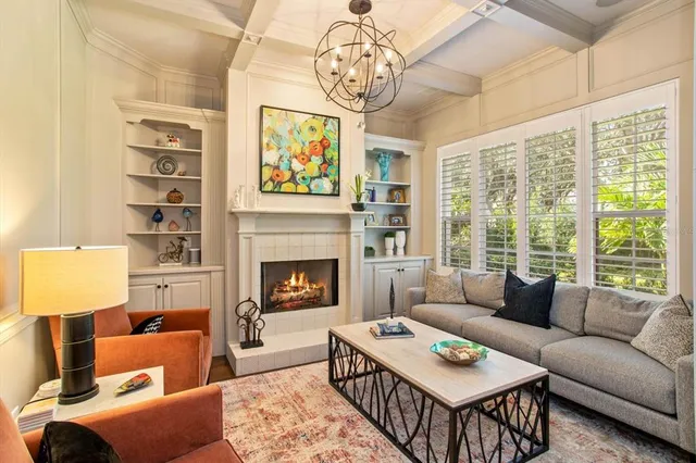 a living room with furniture a fireplace and a table