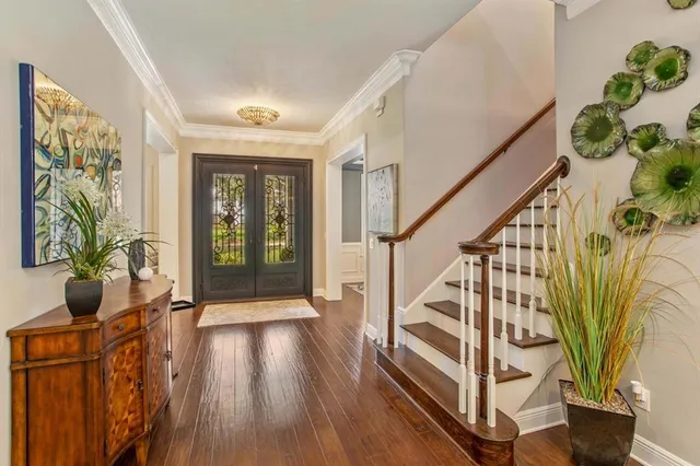 a view of an entryway with wooden floor and a potted plant