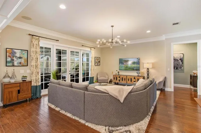 a living room with furniture and a chandelier