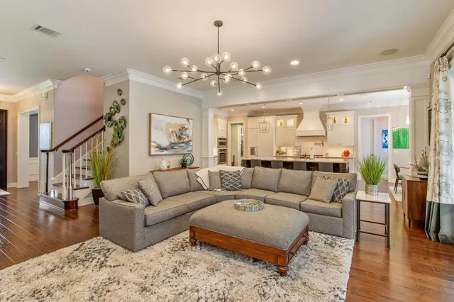 a living room with furniture and a chandelier