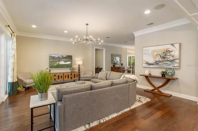 a living room with furniture and a chandelier