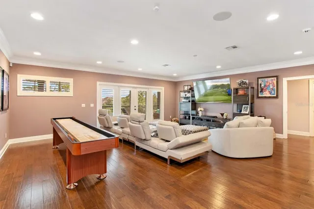 a living room with furniture and wooden floor