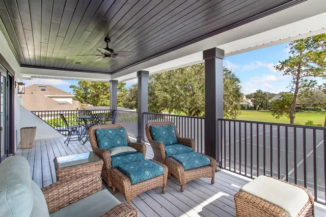 a balcony with furniture and a potted plant