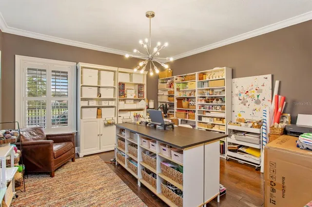 a kitchen with stainless steel appliances granite countertop a stove and a chandelier