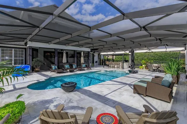 a view of a patio with table and chairs potted plants and palm trees