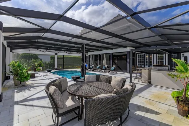 an aerial view of a house with a yard basket ball court and outdoor seating
