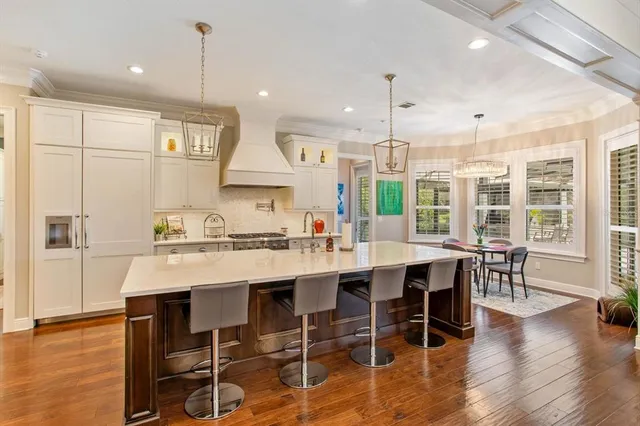 a large kitchen with a table and chairs