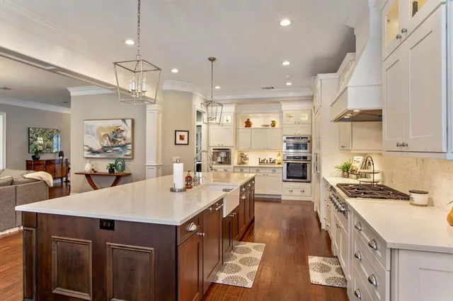 a kitchen with granite countertop a sink a counter space appliances and cabinets