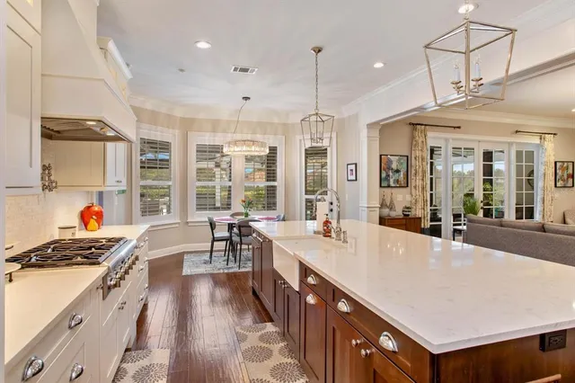 a large kitchen with stainless steel appliances lots of counter space and a large window