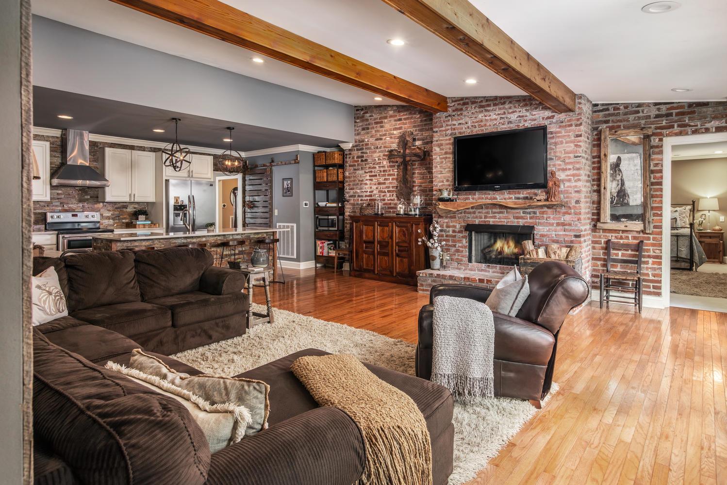 401 Page Road Nashville, TN 37205 - Photo 4 of 30 Exposed antique brick wall! Floating Wood Mantle! New wiring for mounted TV. Gorgeous Open Family Room/Kitchen is the heart of the home! Antique barn doors are the perfect touch for the pantry!