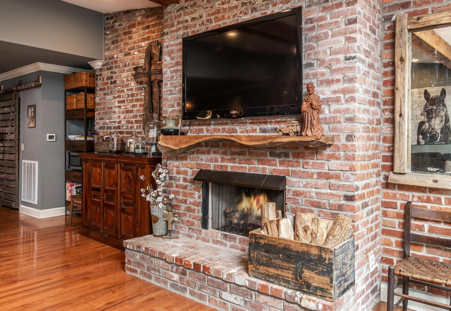 401 Page Road Nashville, TN 37205 - Photo 6 of 30 Can't get enough of this antiqued exposed brick wall! The new floating wood mantle is perfect for the space!