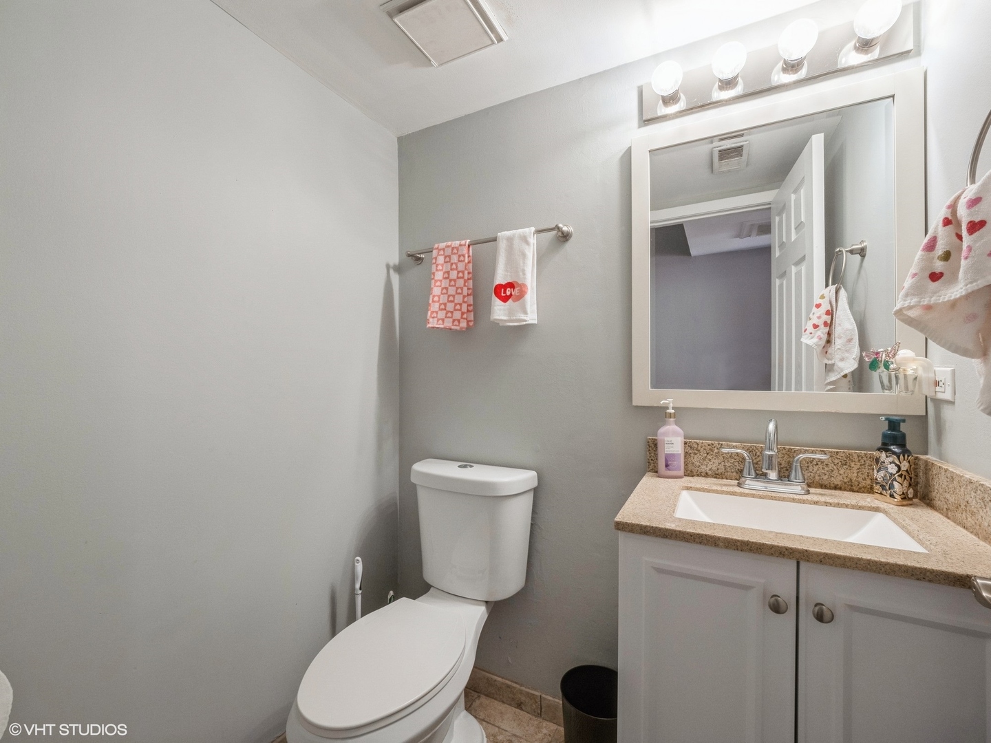 2012 Raleigh Place Hoffman Estates, IL 60169 - Photo 8 of 14 a bathroom with a toilet sink vanity and mirror