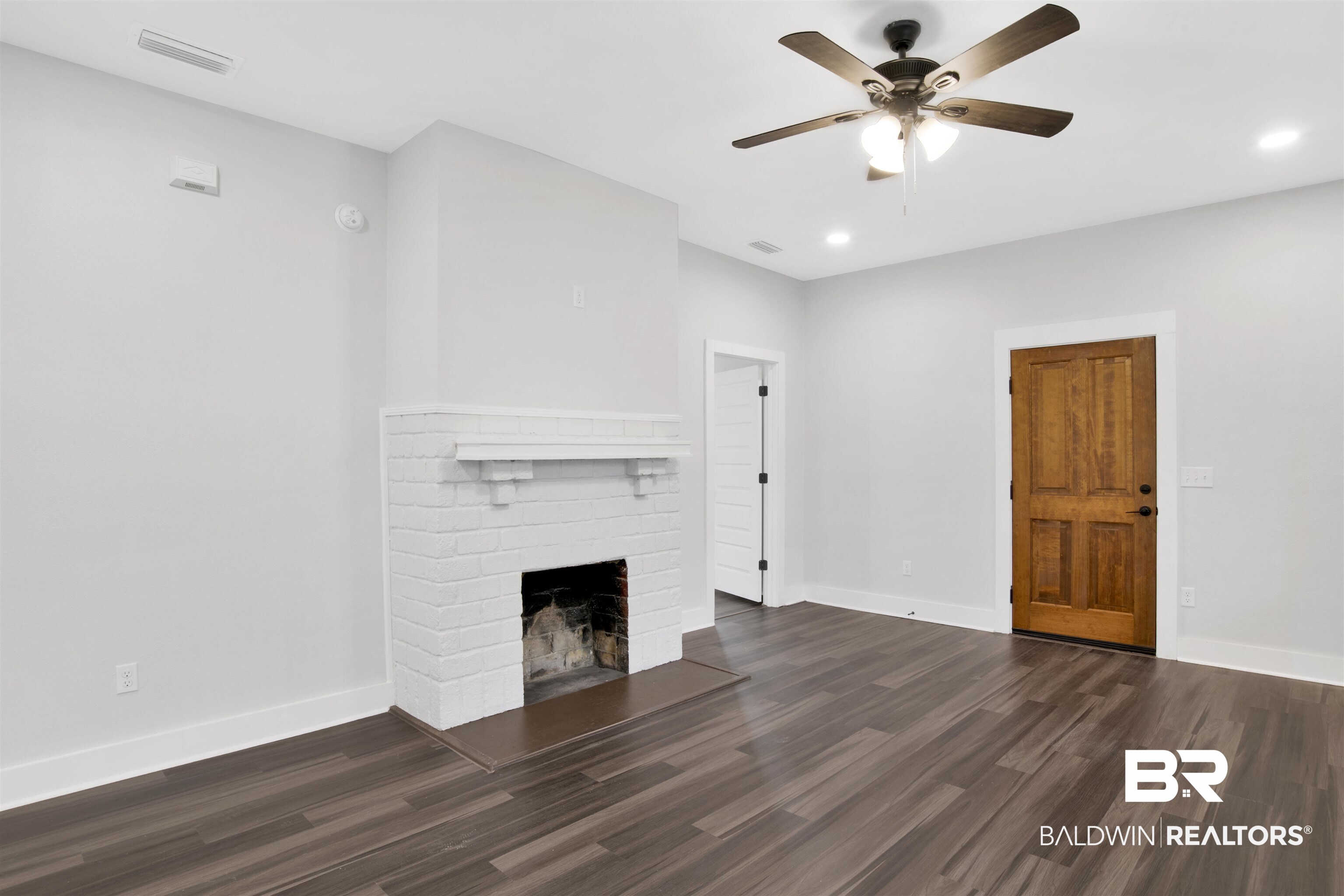 302 1st Street Mobile, AL 36611 - Photo 5 of 28 Unfurnished living room with a fireplace, dark wood-type flooring, and ceiling fan