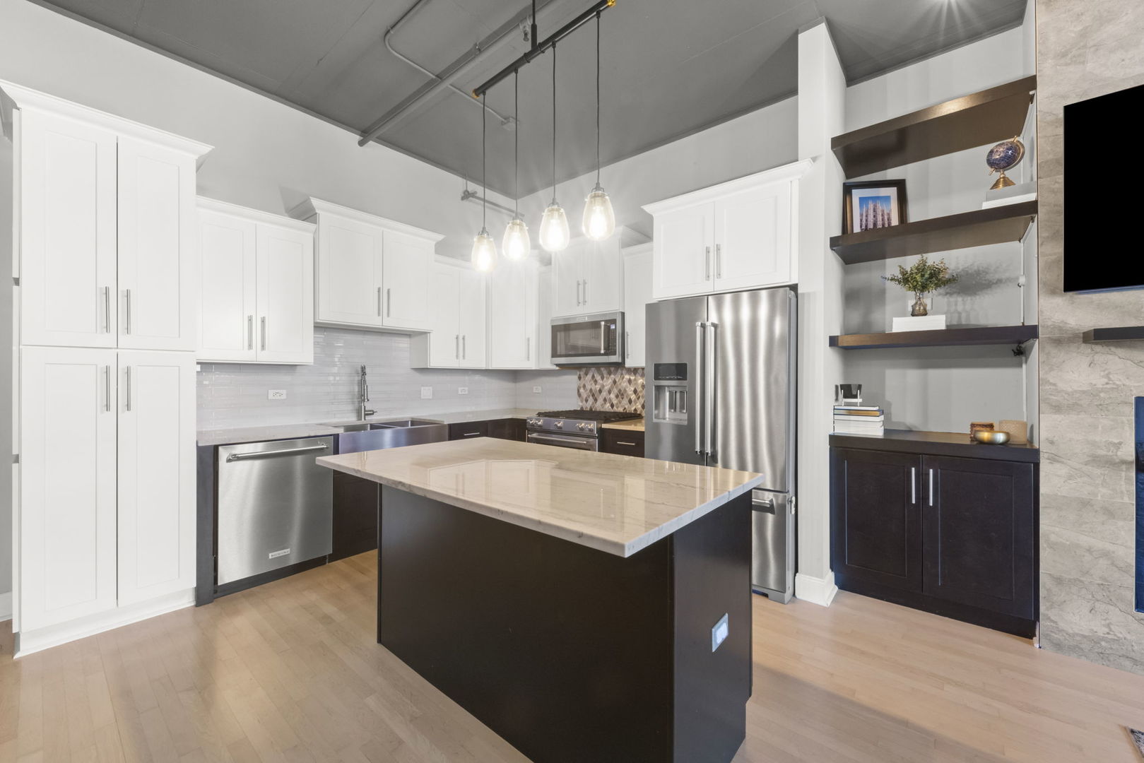 1301 West Madison Street, Unit 305 Chicago, IL 60607 - Photo 3 of 22 a kitchen with stainless steel appliances granite countertop a refrigerator a stove top oven a sink and dishwasher
