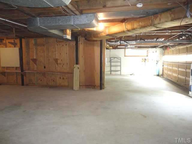 6120 Yates Mill Pond Road Raleigh, NC 27606 - Photo 21 of 23 Workshop area and 2 car garage area in basement Parking Lot/Garage
