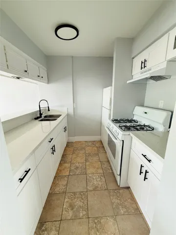a kitchen with granite countertop a sink and cabinets