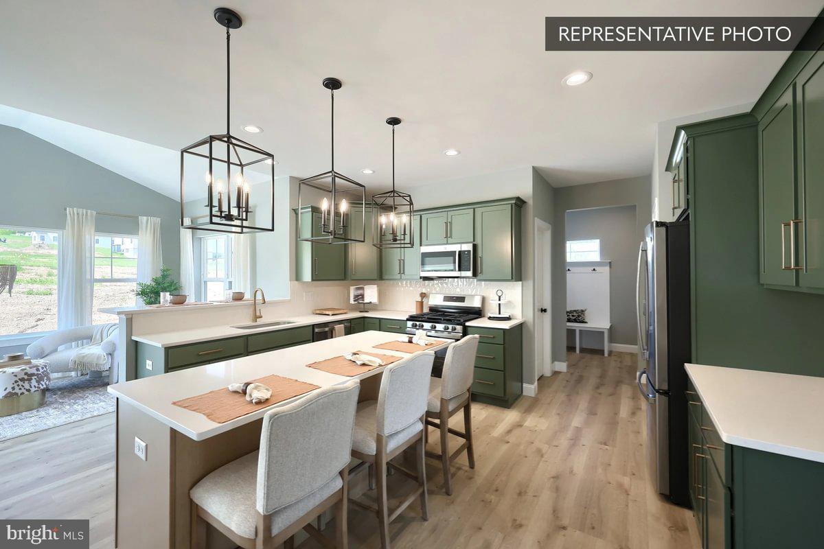 2010 Settlers Ridge Road Slatington, PA 18080 - Photo 10 of 21 a kitchen with stainless steel appliances granite countertop a sink a stove a refrigerator and chairs