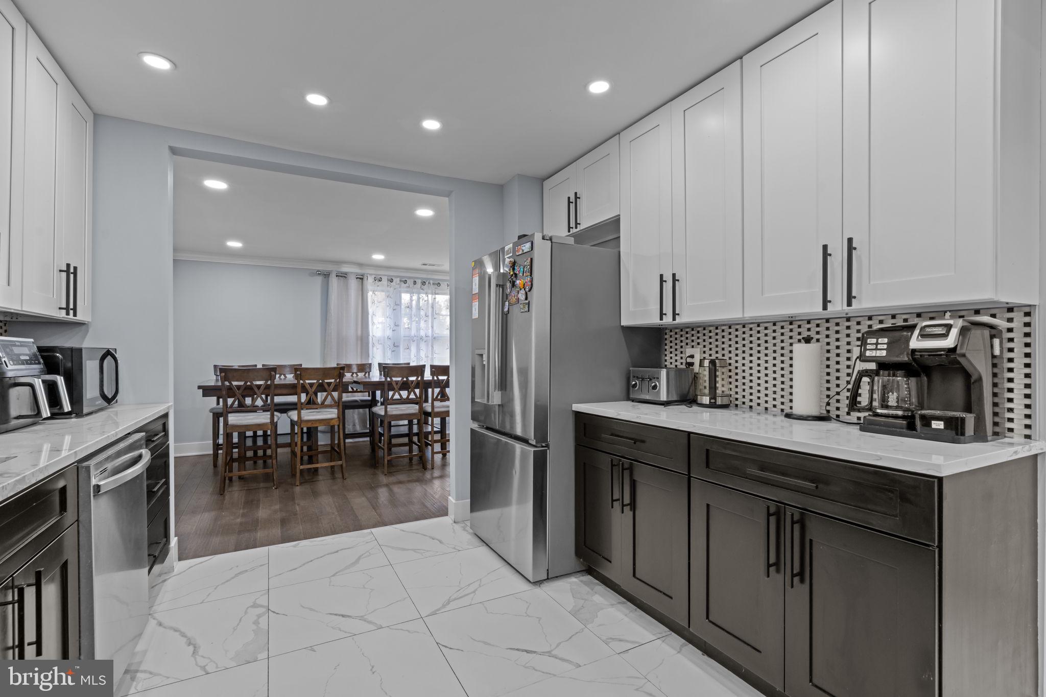 245 Trenton Road Fairless Hills, PA 19030 - Photo 13 of 43 a kitchen with stainless steel appliances granite countertop a stove a sink a oven a dining table and chairs