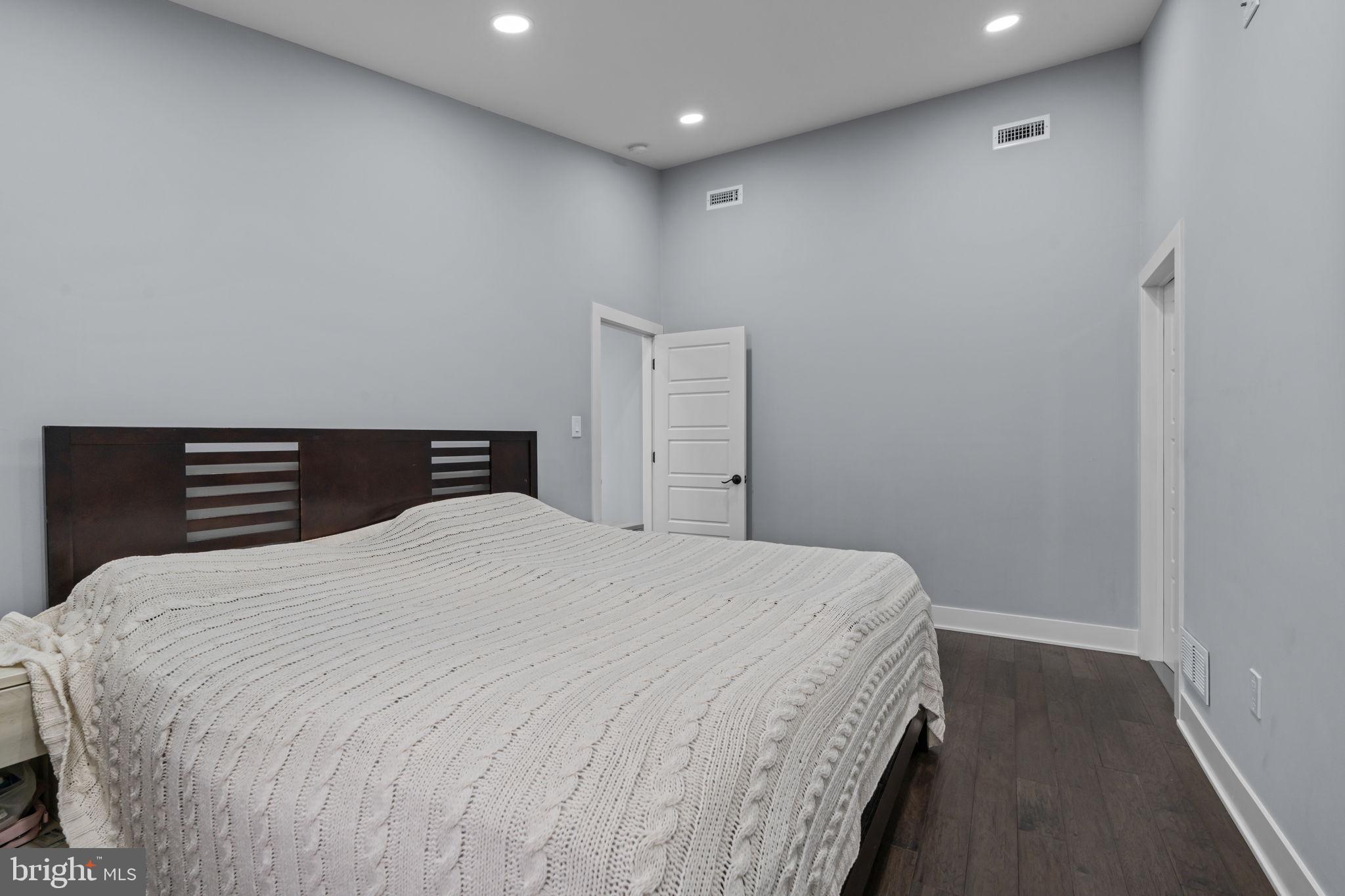 245 Trenton Road Fairless Hills, PA 19030 - Photo 19 of 43 a bedroom with a bed and wooden floor