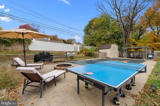 a house view with a sitting space fire pit and outdoor space