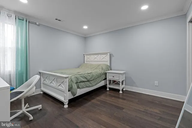 a bedroom with a bed and a chair in it