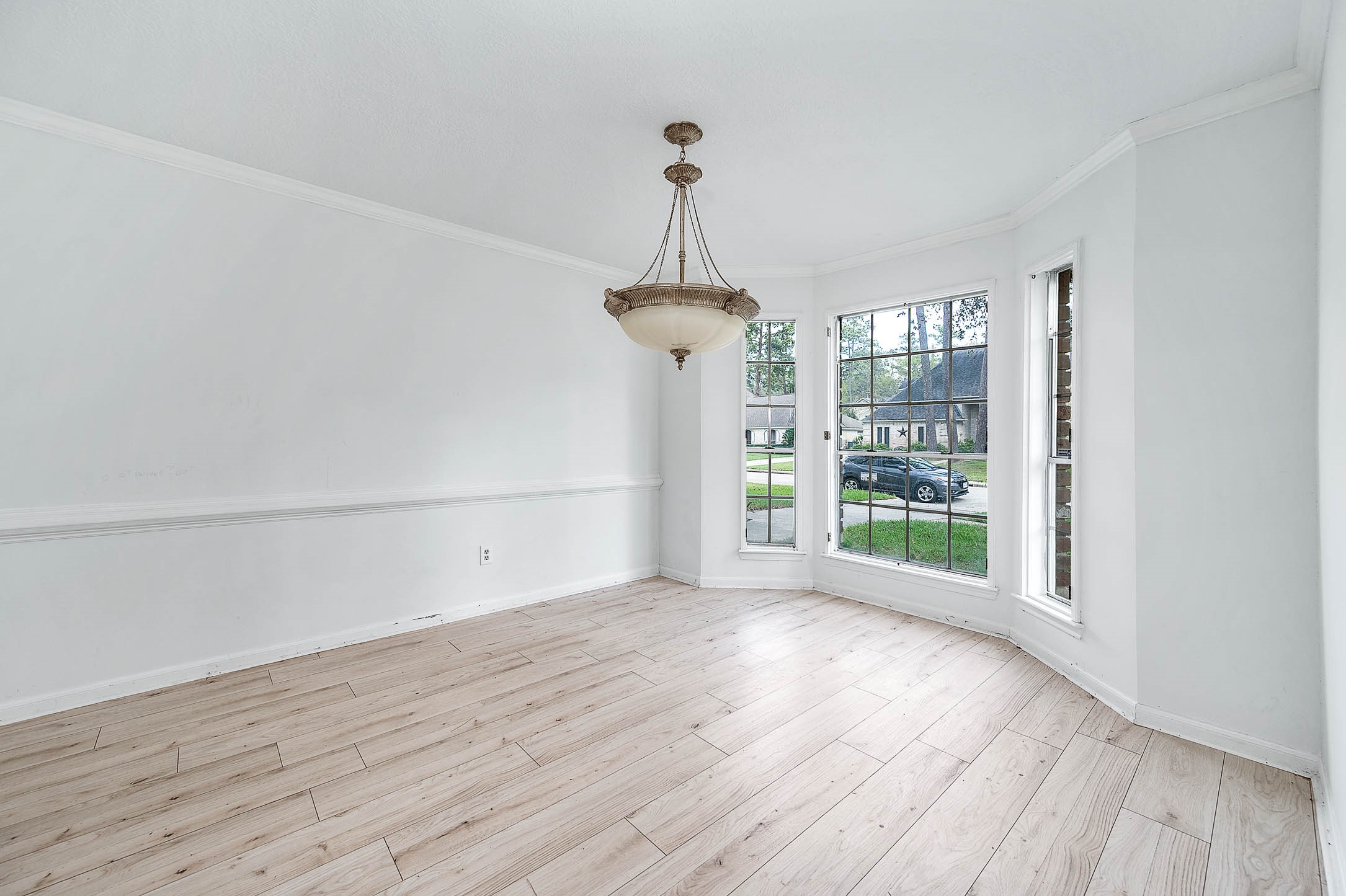 17627 Terrawren Lane Spring, TX 77379 - Photo 16 of 30 a view of a room with wooden floor a ceiling fan and windows
