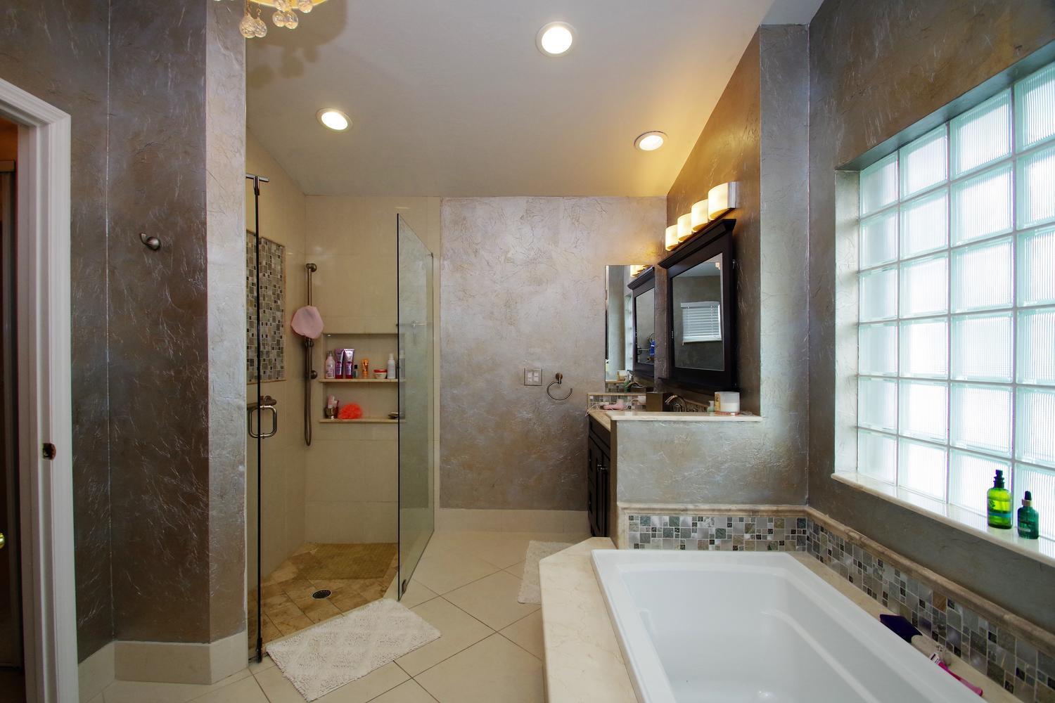 6535 Colomera Drive Boca Raton, FL 33433 - Photo 20 of 36 a bathroom with a tub a sink and a shower