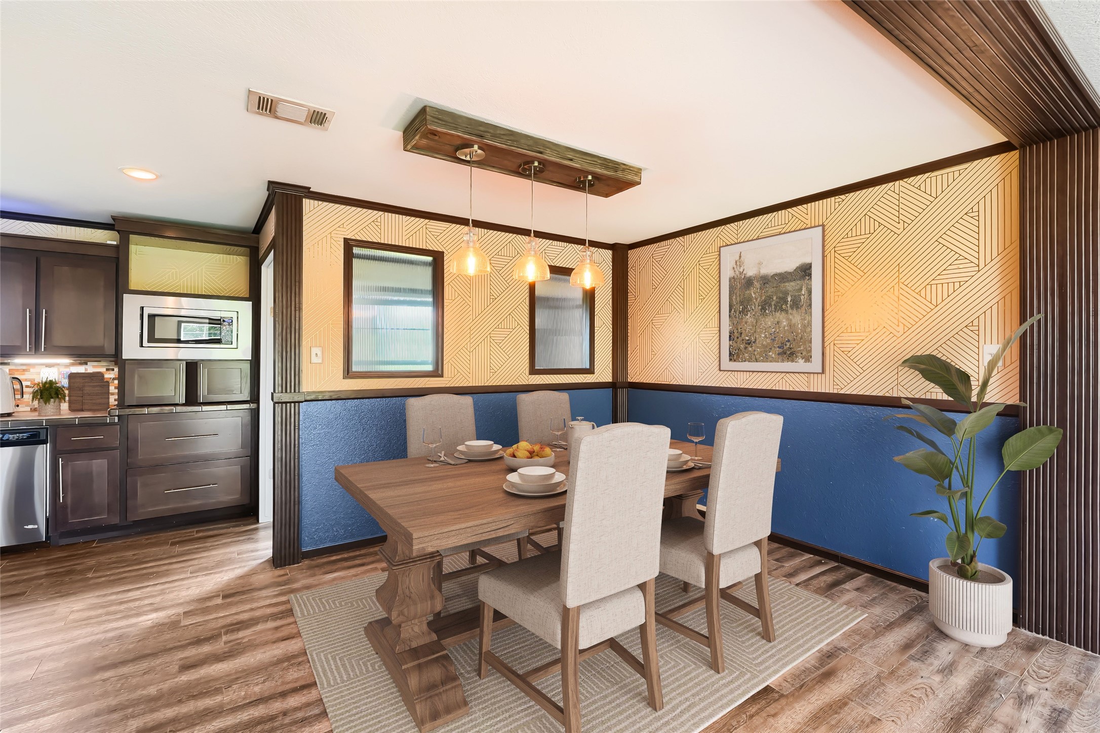 401 Graef Road Kyle, TX 78640 - Photo 11 of 30 Natural light illuminates this dining area, featuring stylish wooden flooring and a modern light fixture.